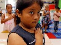 1009397793 ma nb HayMacFistDay  Dyna Gomez, 7, joins her second grade classmates in pledging allegiance to the flag on their first day of school at the Hayden McFadden Elementary School in New Bedford.  PETER PEREIRA/THE STANDARD-TIMES/SCMG : education, school, students